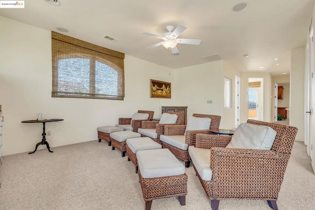 living room with light carpet and ceiling fan