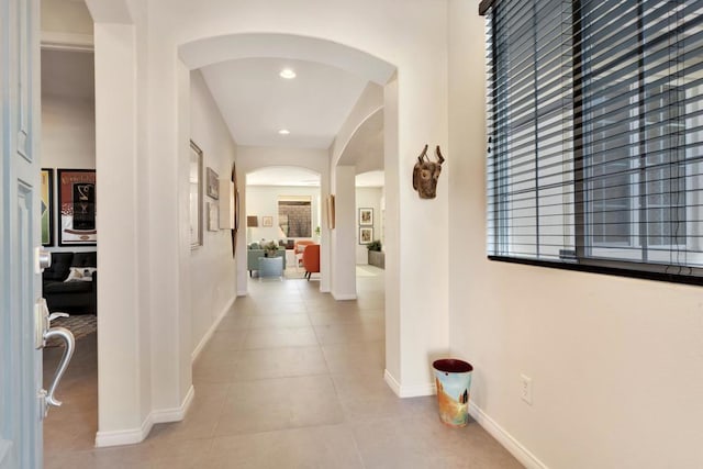 hall featuring light tile patterned floors