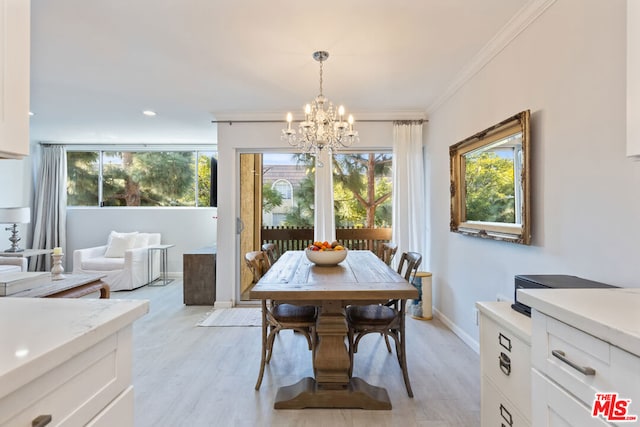 dining area with a chandelier, crown molding, and light hardwood / wood-style floors