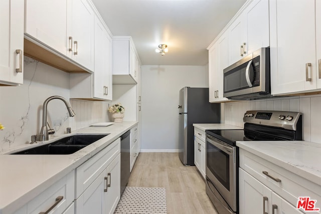 kitchen with sink, white cabinetry, and appliances with stainless steel finishes