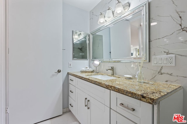 bathroom featuring vanity and tasteful backsplash