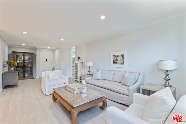 living room with crown molding and light hardwood / wood-style floors