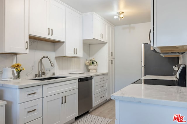 kitchen featuring dishwasher, white cabinetry, stove, sink, and light wood-type flooring