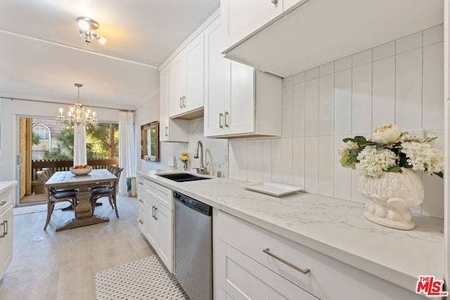 kitchen featuring sink, stainless steel dishwasher, and white cabinets