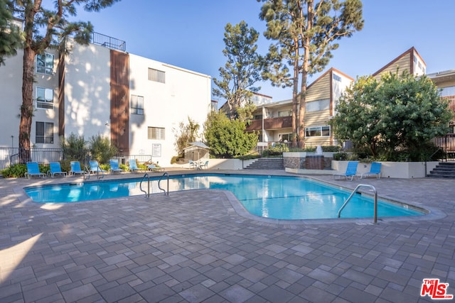 view of swimming pool with a patio