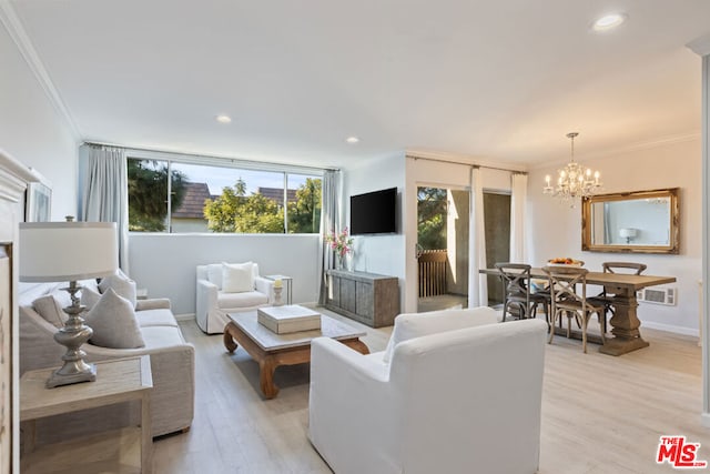 living room with light wood-type flooring, crown molding, and a notable chandelier