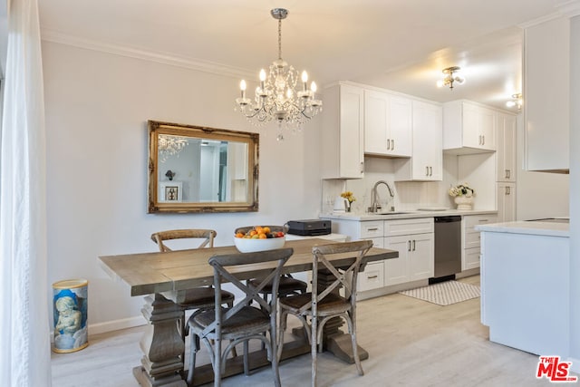 kitchen with decorative light fixtures, white cabinetry, sink, light hardwood / wood-style flooring, and crown molding