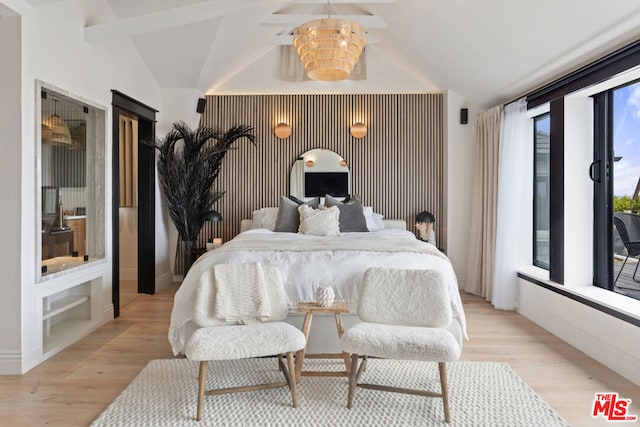 bedroom featuring vaulted ceiling with beams and light wood-type flooring