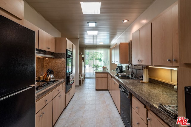 kitchen featuring sink, light brown cabinets, black appliances, and light tile patterned floors