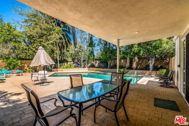 view of patio / terrace with a fenced in pool