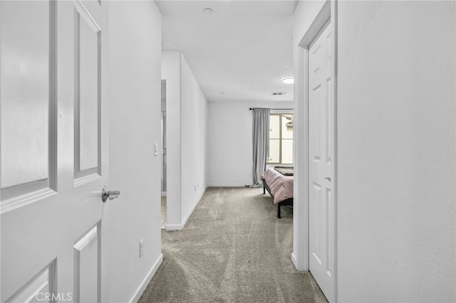 hallway with light colored carpet