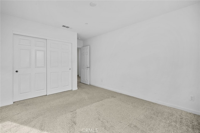 unfurnished bedroom with carpet floors and a closet