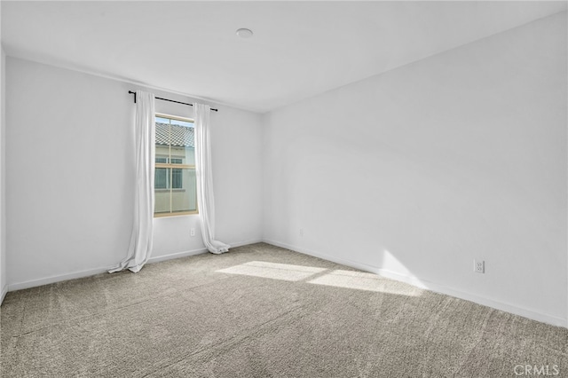 unfurnished room featuring carpet flooring