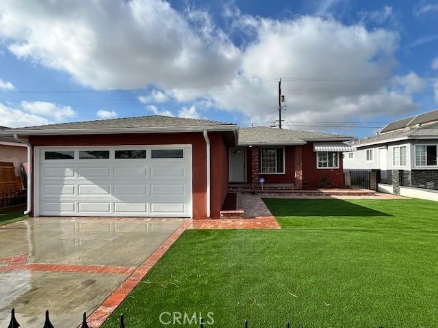 ranch-style home with a garage and a front lawn