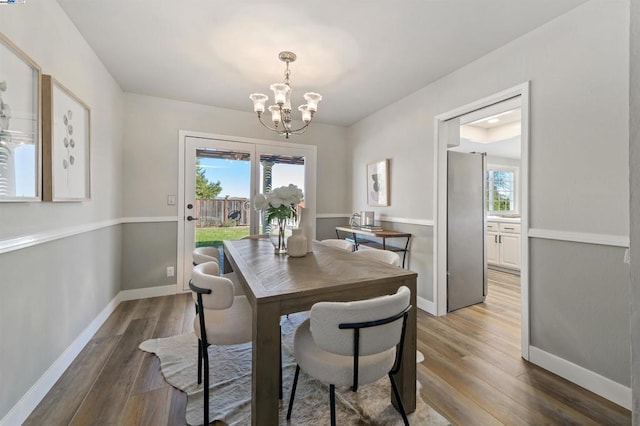 dining area featuring dark hardwood / wood-style floors and a notable chandelier