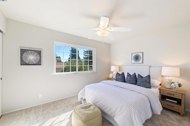 bedroom featuring light carpet and ceiling fan