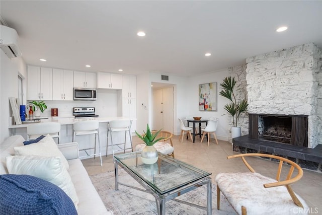 living room featuring a fireplace and a wall mounted AC