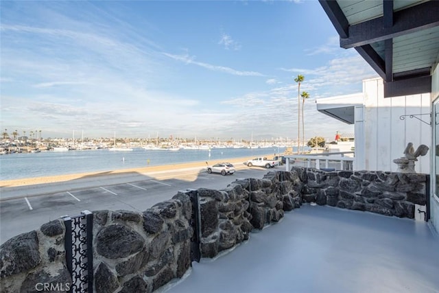 view of patio / terrace featuring a water view and a view of the beach