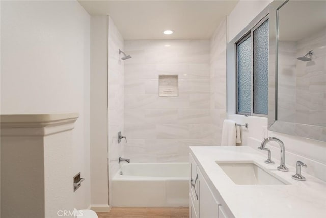 full bathroom with bathtub / shower combination, recessed lighting, vanity, and wood finished floors