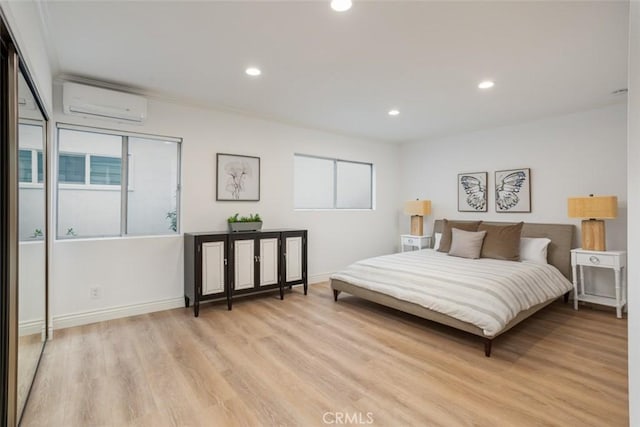 bedroom with light wood-style floors, a wall mounted AC, multiple windows, and recessed lighting