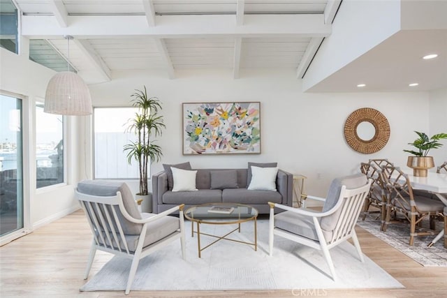 living room with light hardwood / wood-style floors, wooden ceiling, and vaulted ceiling with beams