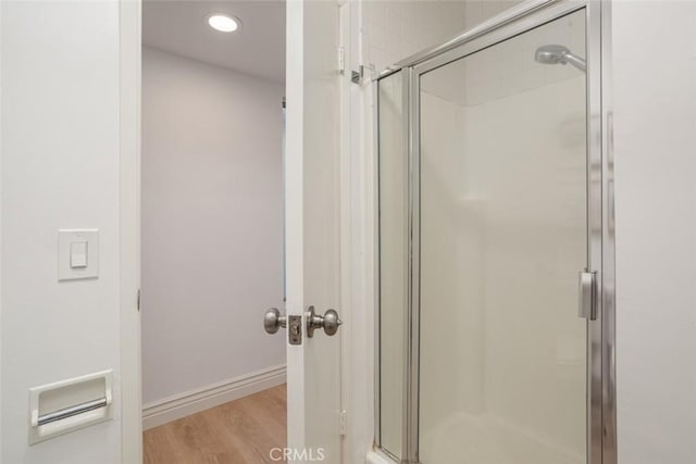 bathroom with hardwood / wood-style floors and walk in shower