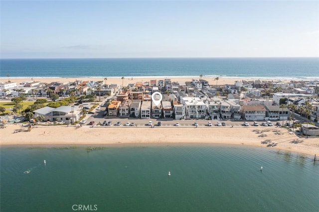 bird's eye view featuring a water view and a beach view