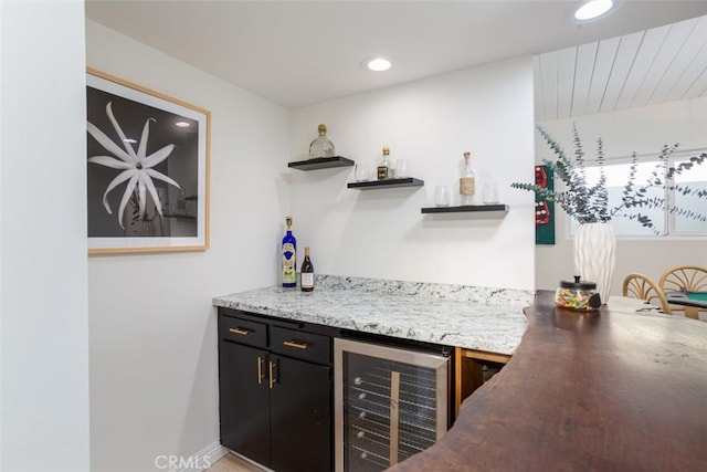 bar featuring a bar, recessed lighting, and wine cooler