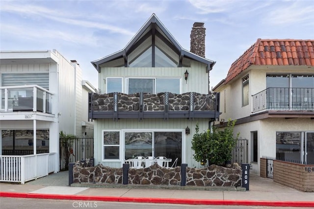 rear view of house featuring a balcony