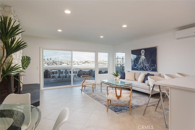 tiled living room featuring a wall mounted AC, a water view, and ornamental molding