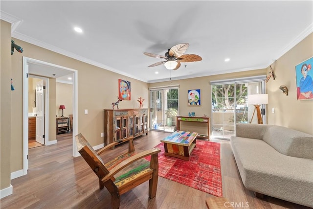 living room with ceiling fan, light hardwood / wood-style flooring, and ornamental molding