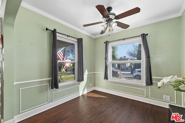 spare room featuring crown molding, wood-type flooring, and ceiling fan