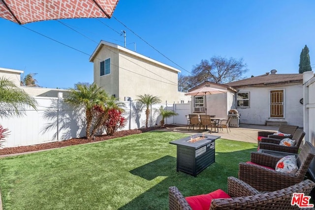 view of yard featuring a fire pit and a patio