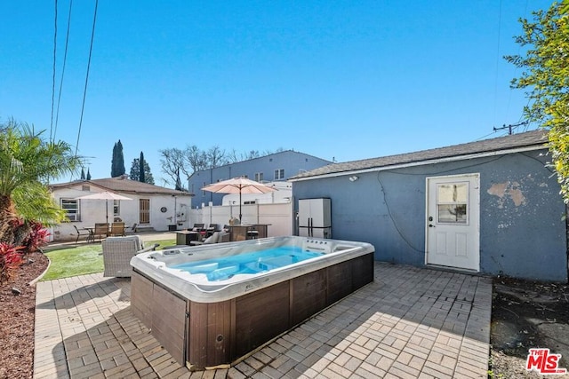 view of pool featuring a patio area and a hot tub