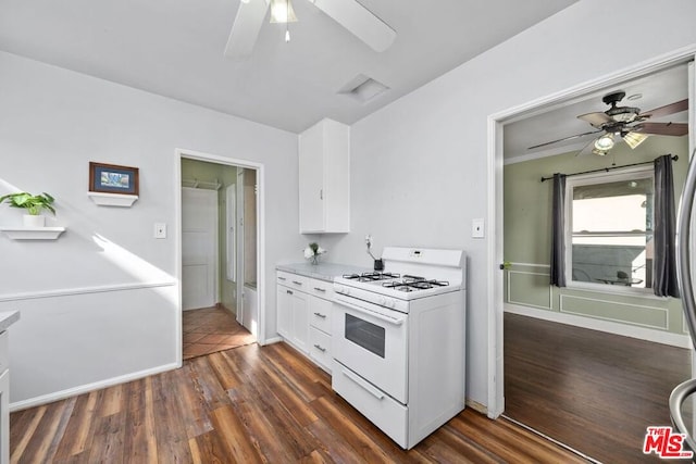 kitchen with white cabinets, ceiling fan, gas range gas stove, and dark hardwood / wood-style flooring