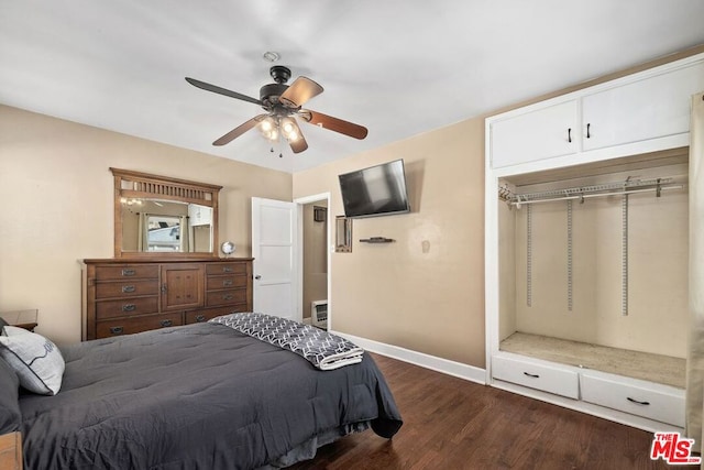 bedroom featuring ceiling fan, dark wood-type flooring, and a closet