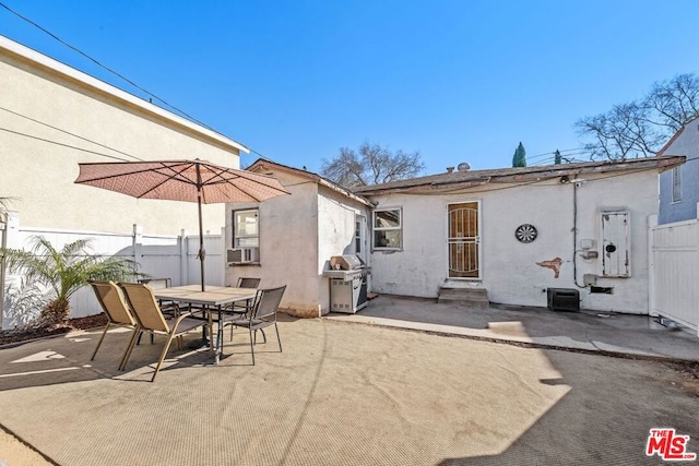 back of property with cooling unit and a patio area