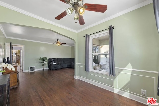 interior space featuring ceiling fan, ornamental molding, and dark hardwood / wood-style flooring