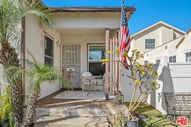 doorway to property with a patio area