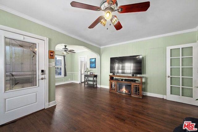 unfurnished living room featuring crown molding, dark wood-type flooring, and a fireplace