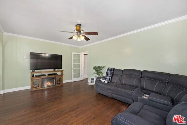 living room with ceiling fan, crown molding, a fireplace, and dark hardwood / wood-style flooring