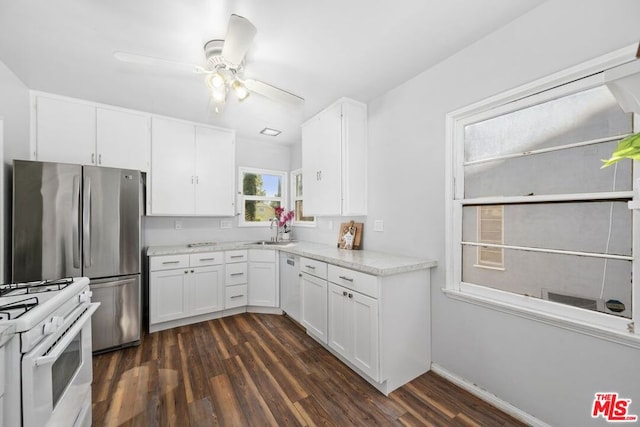 kitchen with white appliances, white cabinets, dark wood-type flooring, and sink