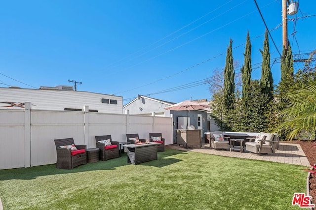 view of yard with a patio and an outdoor living space with a fire pit