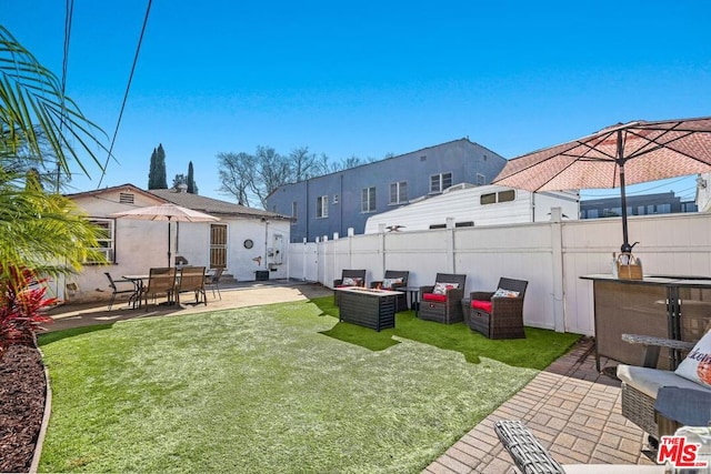 view of yard featuring a patio area and an outdoor living space with a fire pit