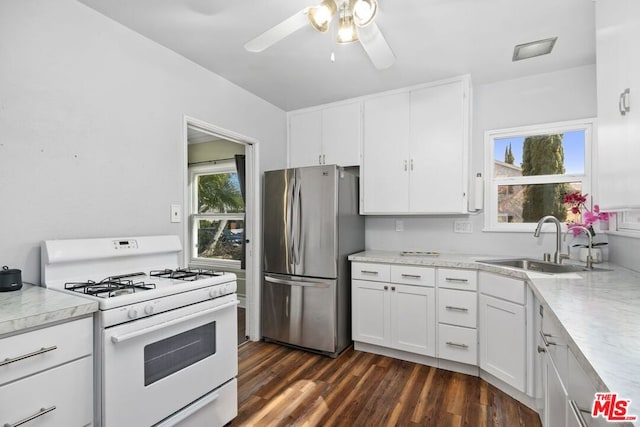 kitchen featuring white cabinetry, sink, dark hardwood / wood-style floors, stainless steel refrigerator, and white range with gas stovetop