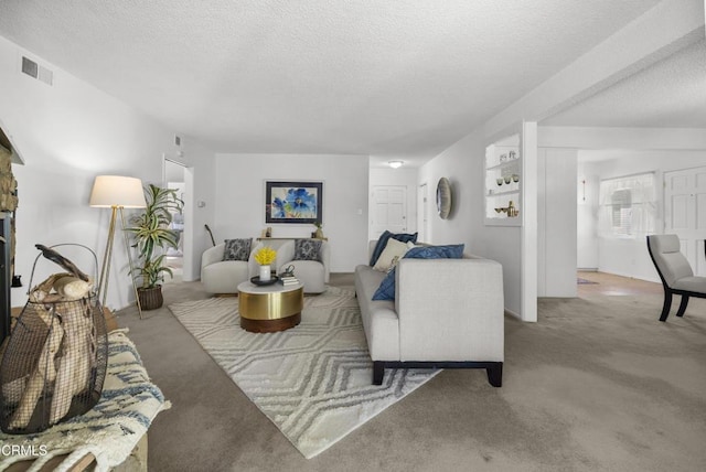 living room with a fireplace, a textured ceiling, and carpet