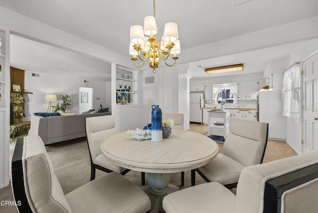 dining area featuring a chandelier and a textured ceiling