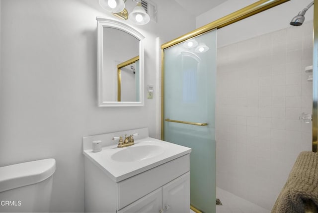 bathroom with toilet, vanity, and walk in shower