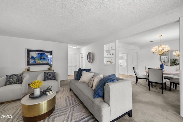 living room featuring carpet floors, an inviting chandelier, and a textured ceiling