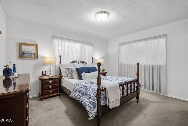 carpeted bedroom featuring a textured ceiling